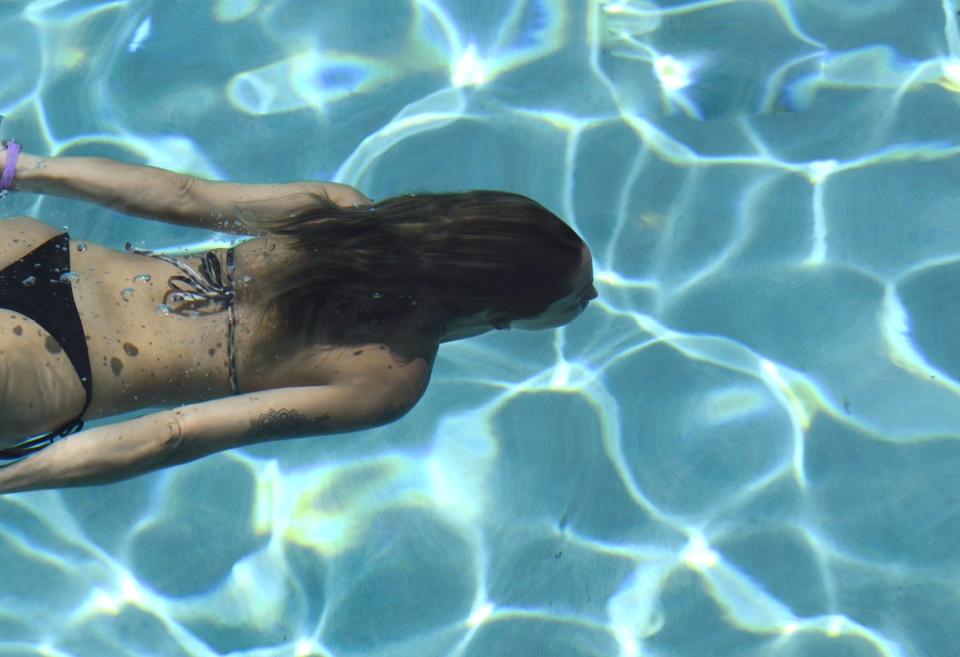 person swimming in a pool